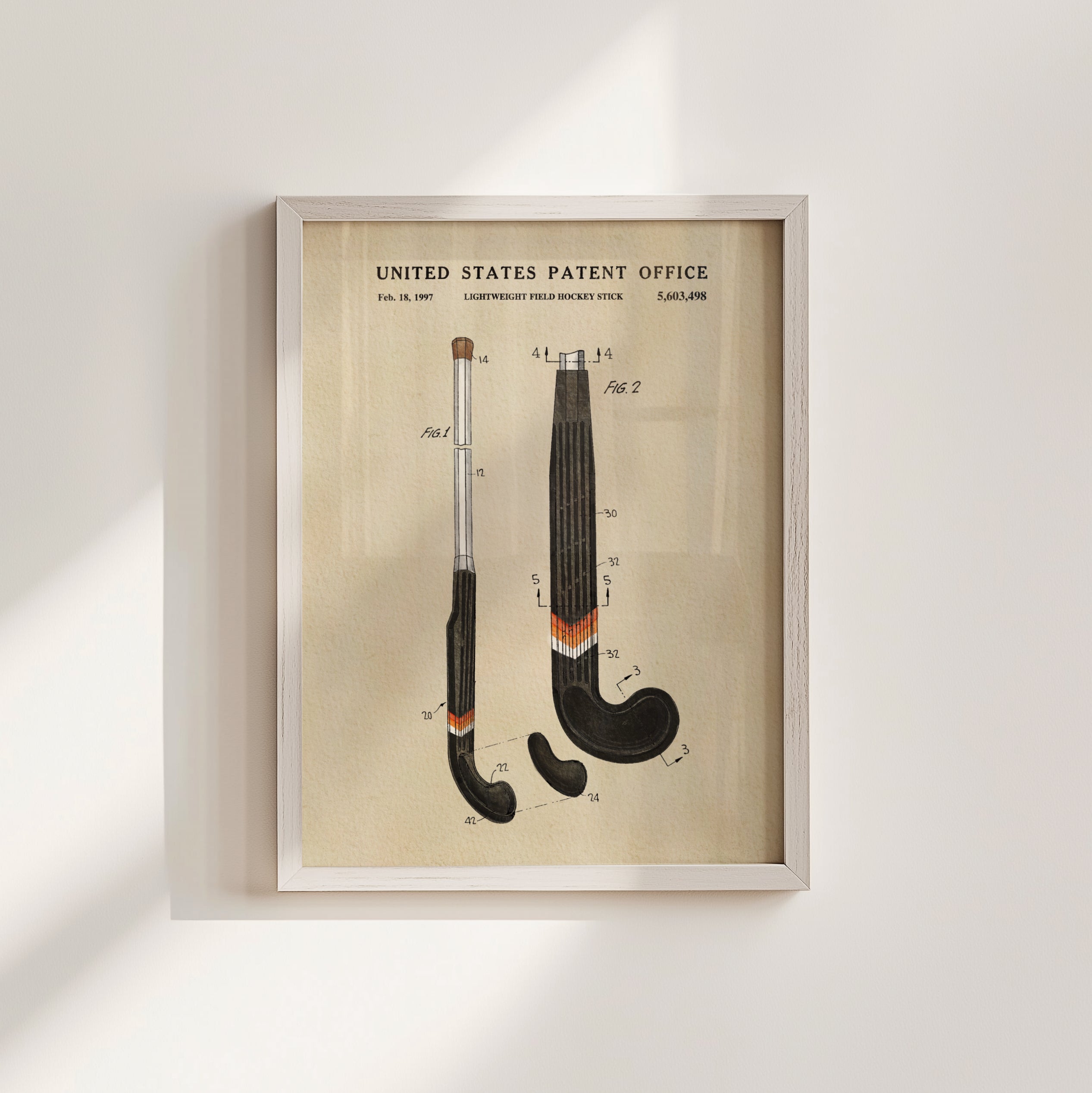 The image is a framed patent drawing depicting two hockey sticks with detailed technical drawings and labels.
