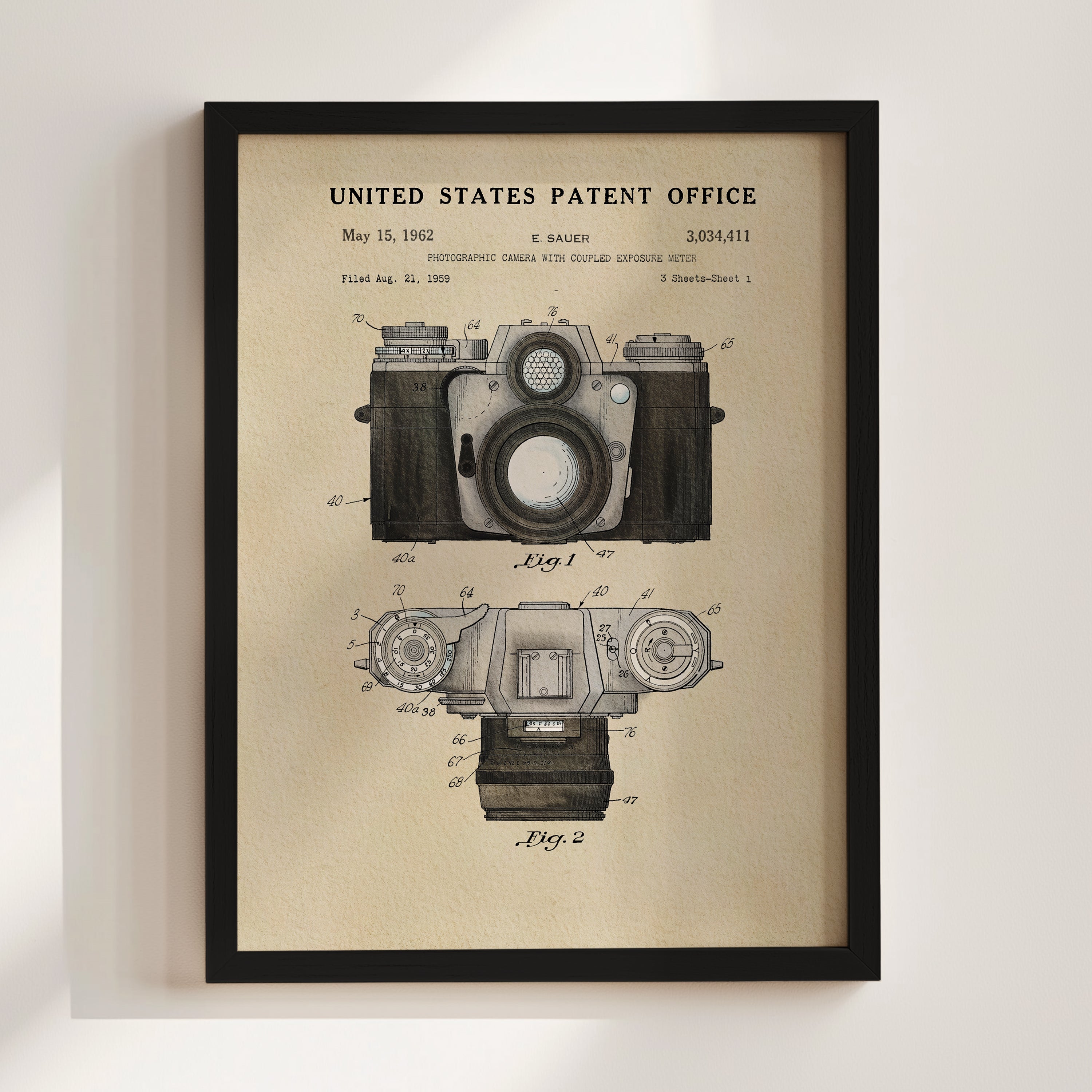The image is a framed vintage patent drawing of a camera, depicting the design and features of the camera in a technical drawing style.