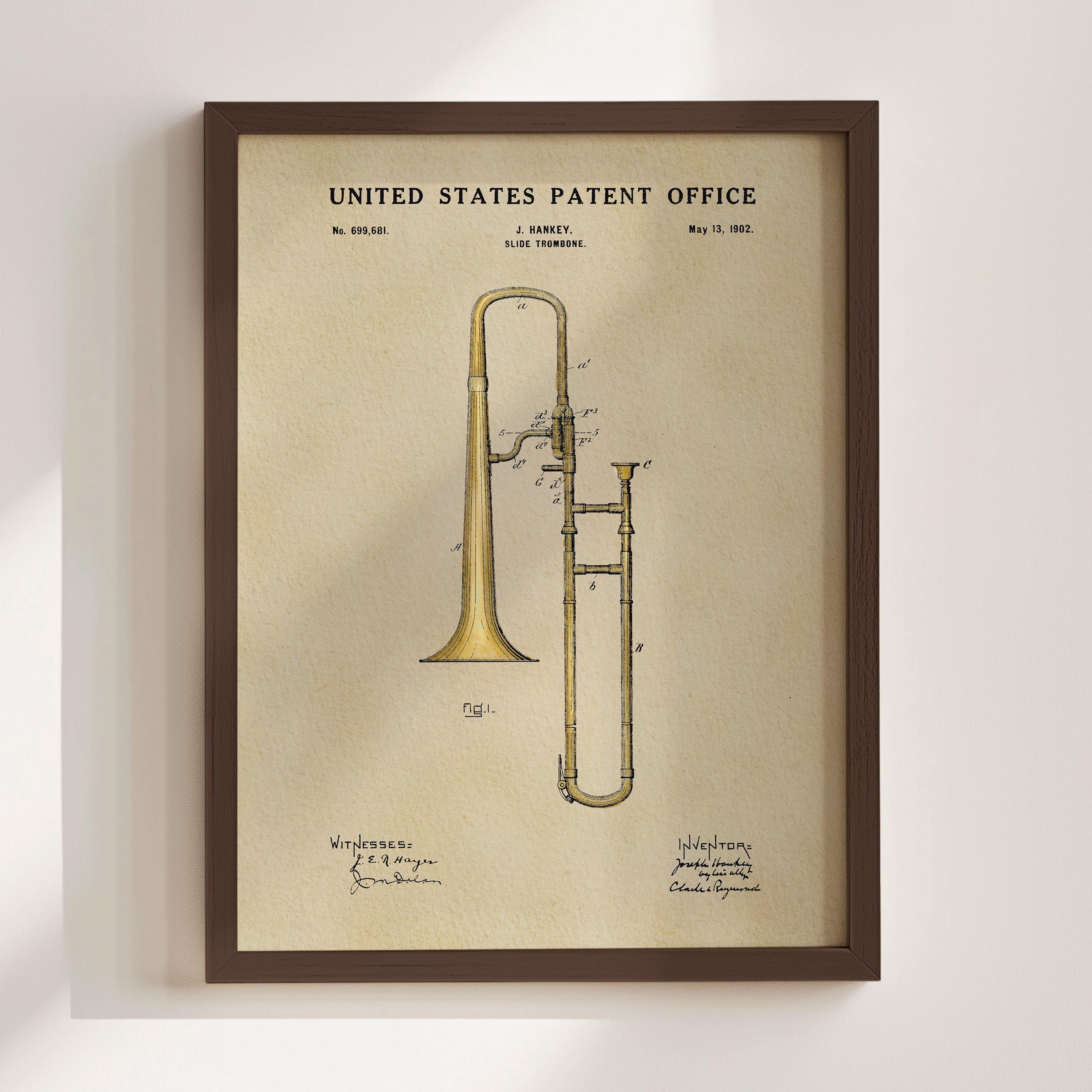 The image is a framed print of a patent drawing for a trumpet, depicting the instrument in a detailed and technical manner.