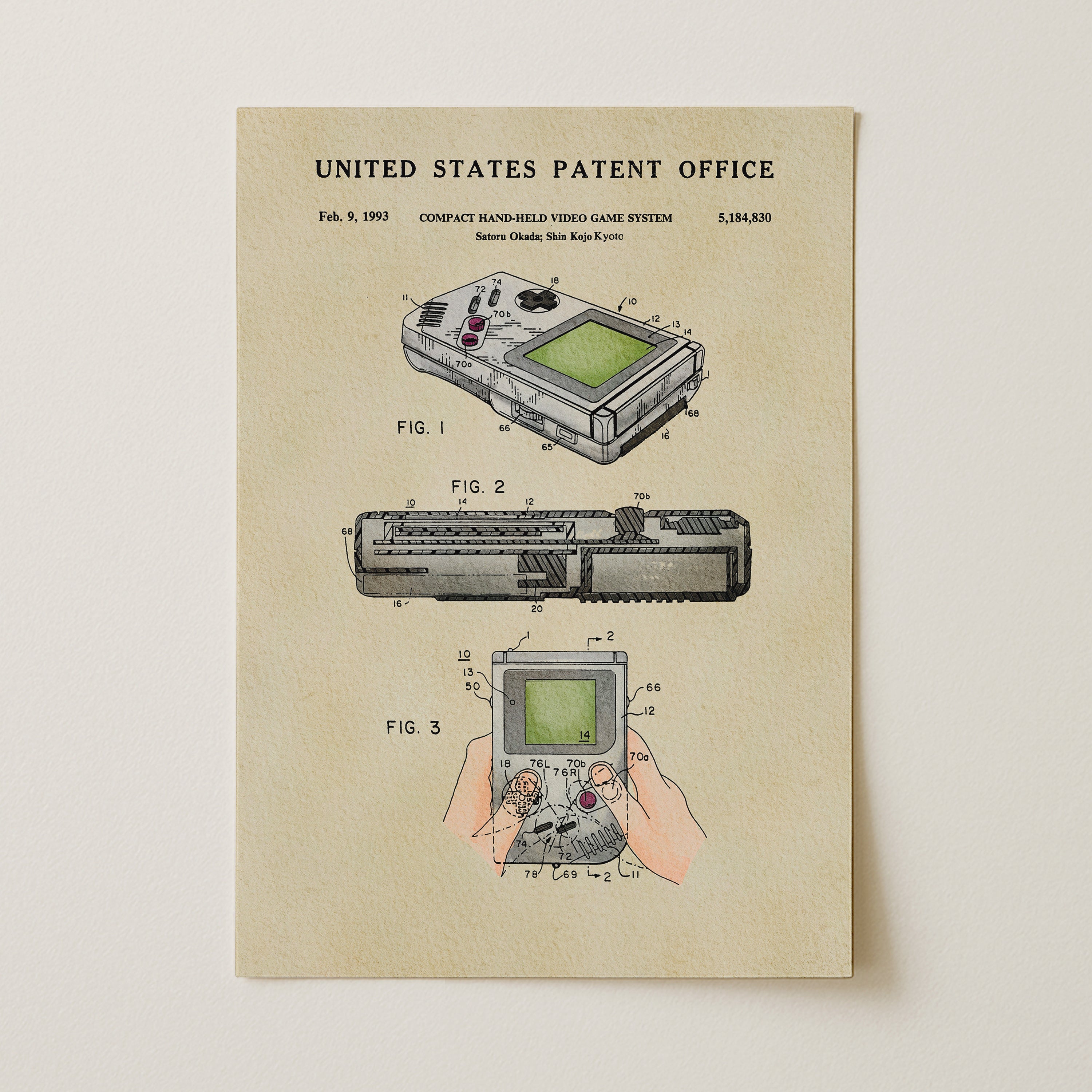 The image is a patent illustration depicting a compact handheld video game system, specifically the Nintendo GameCube, with three different views of the device.