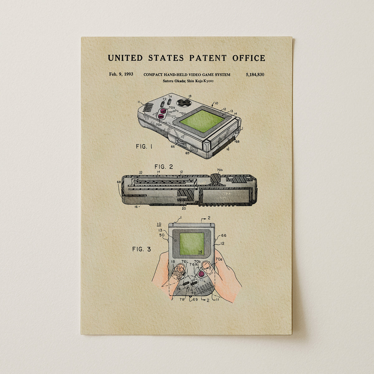The image is a patent illustration depicting a compact handheld video game system, specifically the Nintendo GameCube, with three different views of the device.