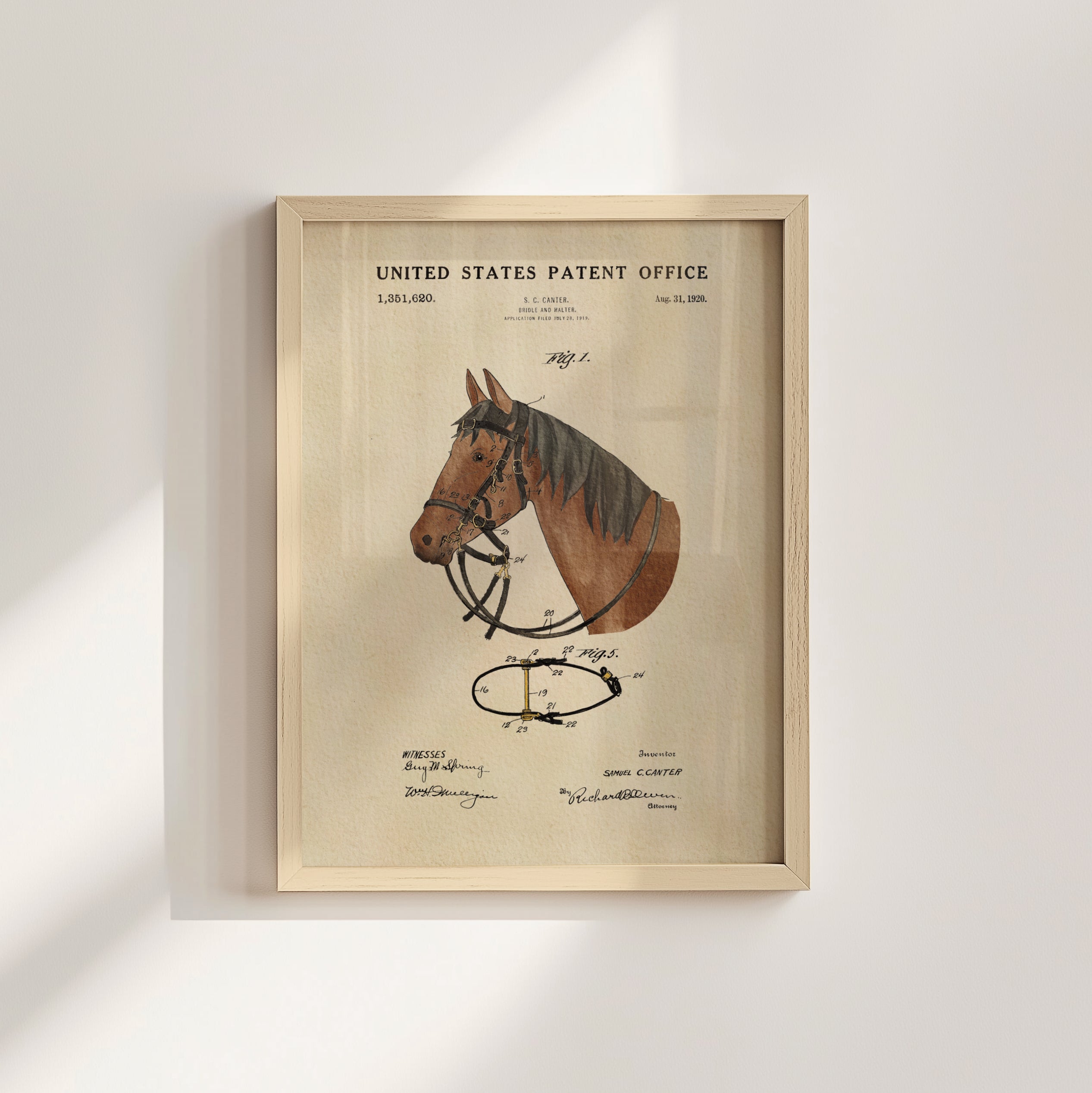 The image is a framed print of a horse's head with a detailed drawing and text, likely a patent drawing, against a white wall.