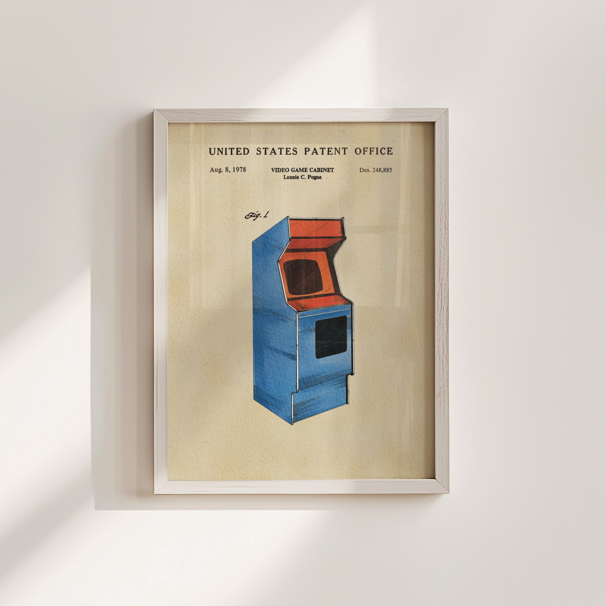 The image is a framed patent drawing of a blue arcade cabinet, depicting a retro gaming console from the 1980s.