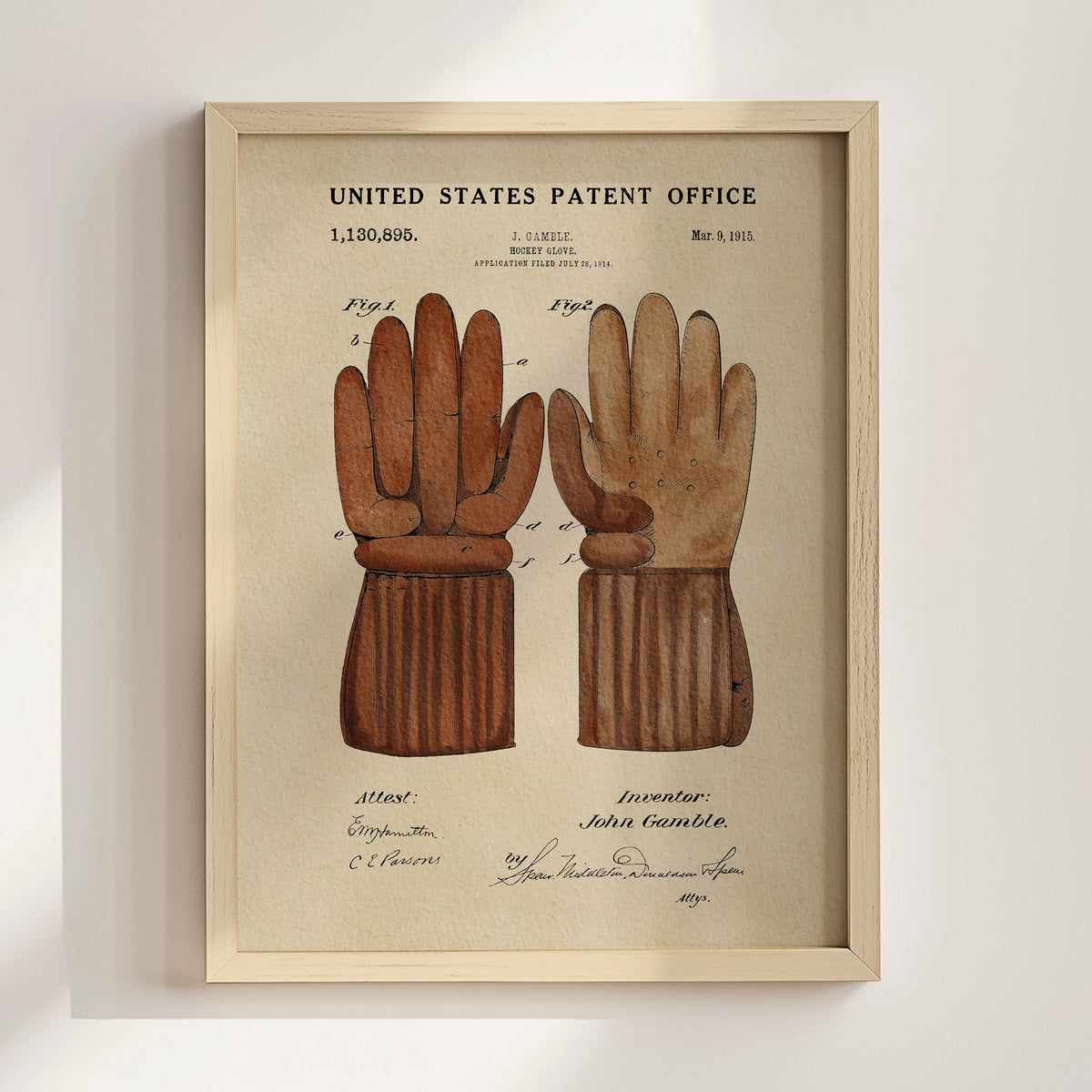 The image is a framed print of a United States patent office patent from 1885, featuring a detailed illustration of a pair of brown leather gloves.