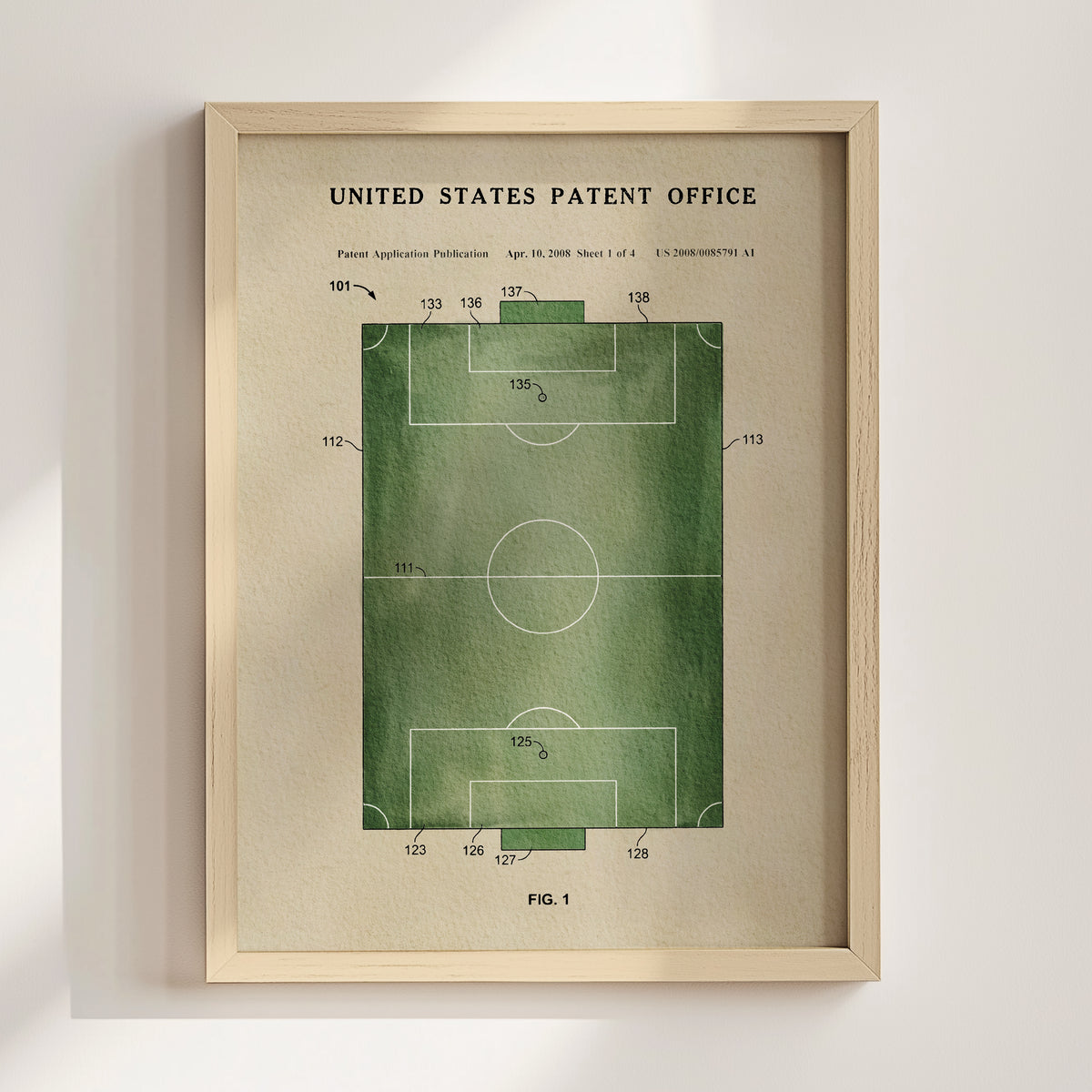 The image is a framed print of a patent application for a soccer field, with a green field design and various technical drawings and measurements.
