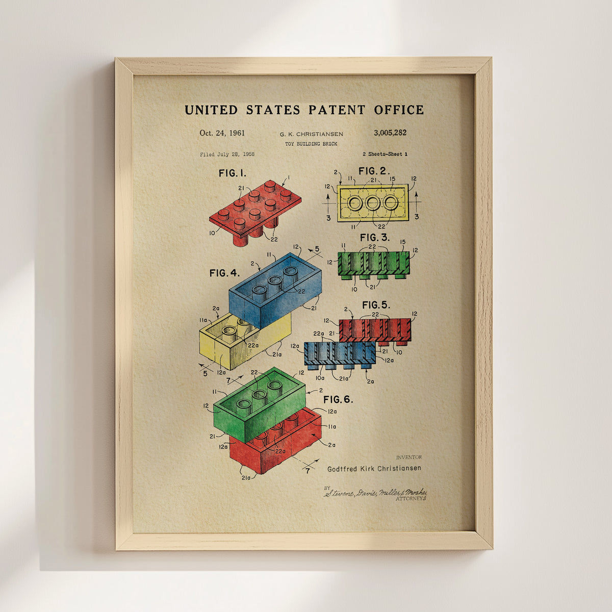 The image is a framed patent drawing depicting various Lego brick designs, including a blue brick, a red brick, and a yellow brick.
