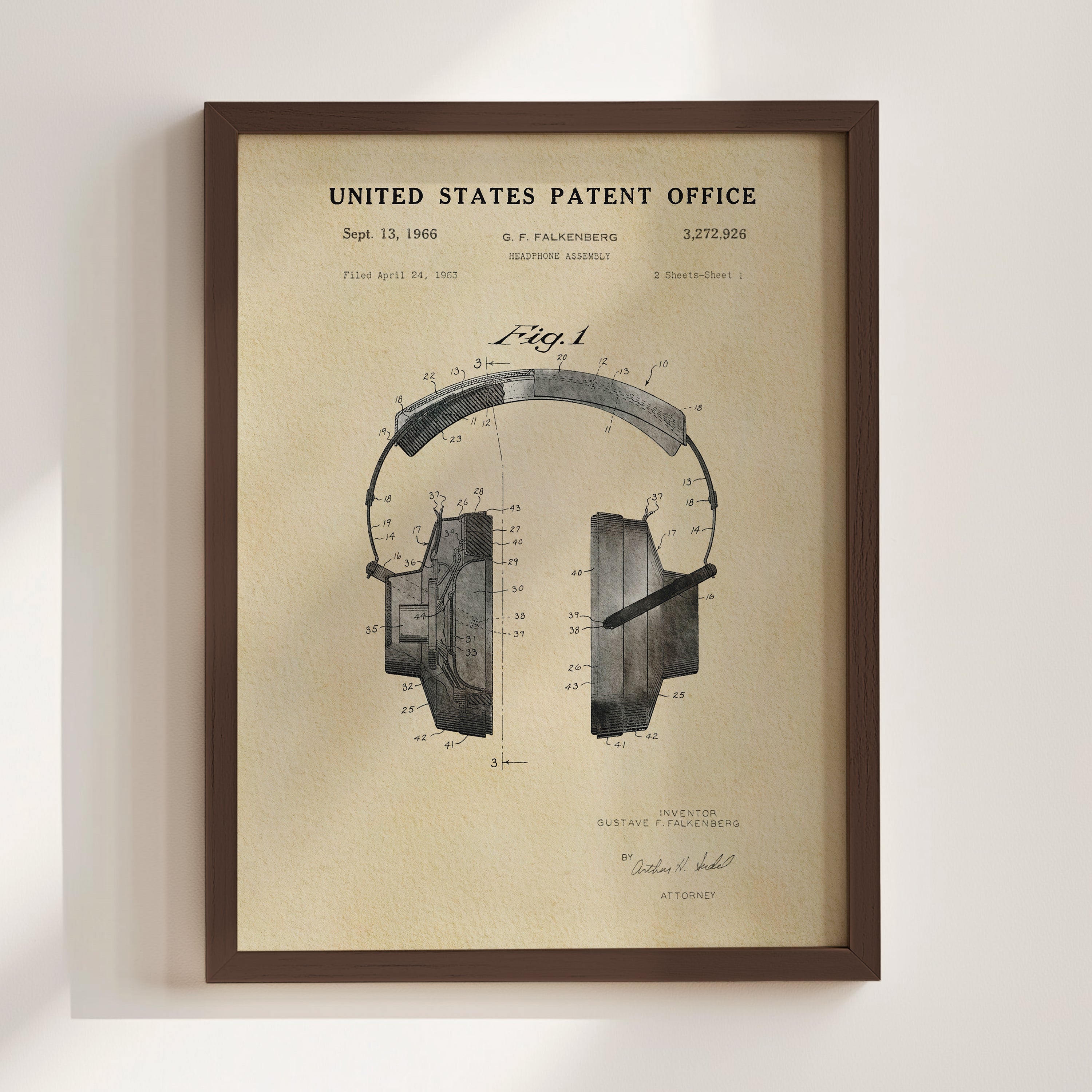 The image is a framed vintage patent drawing of a pair of headphones, depicting the design and features of the headphones.