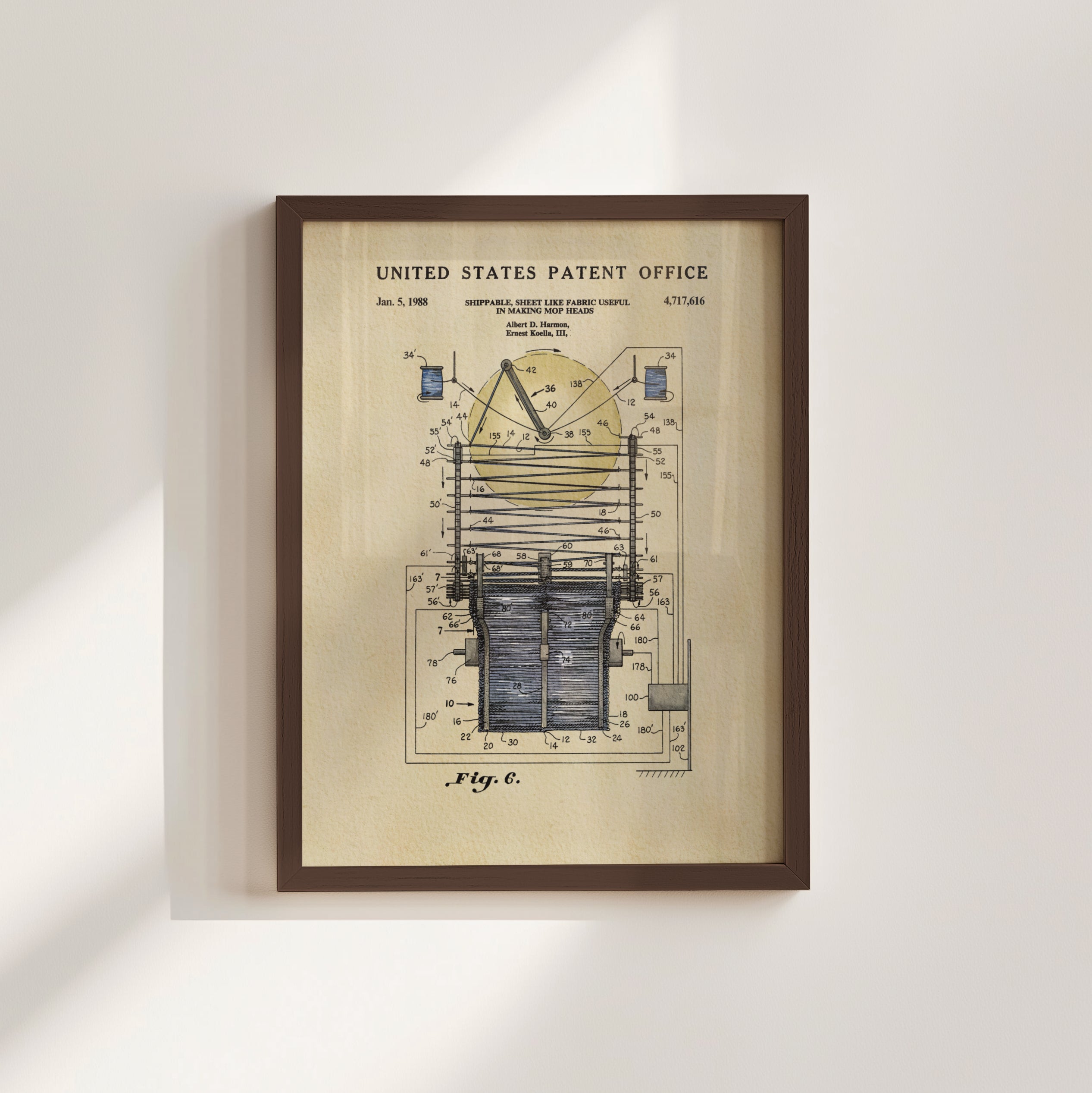 The image is a framed patent drawing depicting a technical drawing of a device with a yellow background and various components and labels.