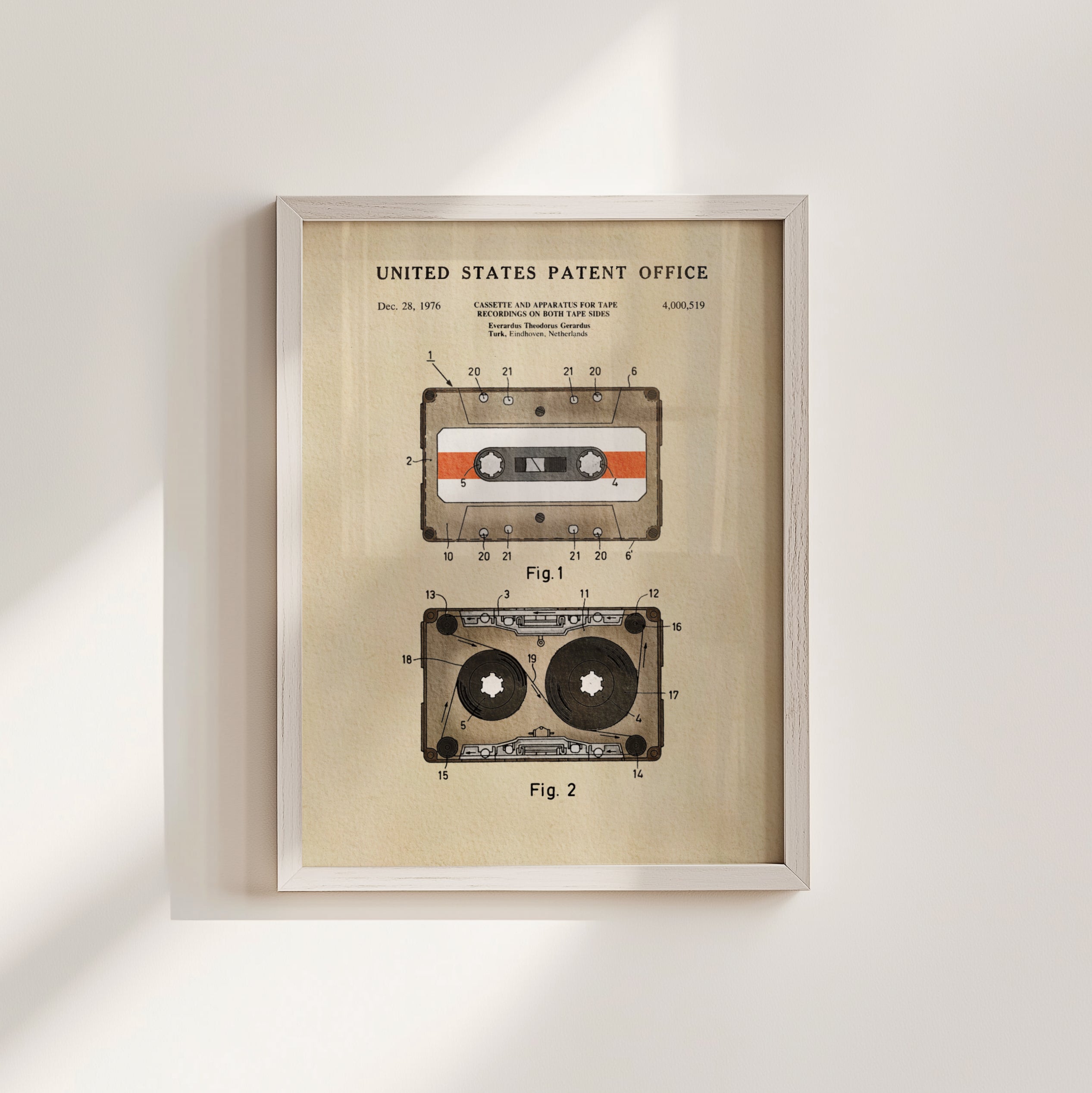 The image is a framed patent drawing depicting two cassette tapes, one labeled 