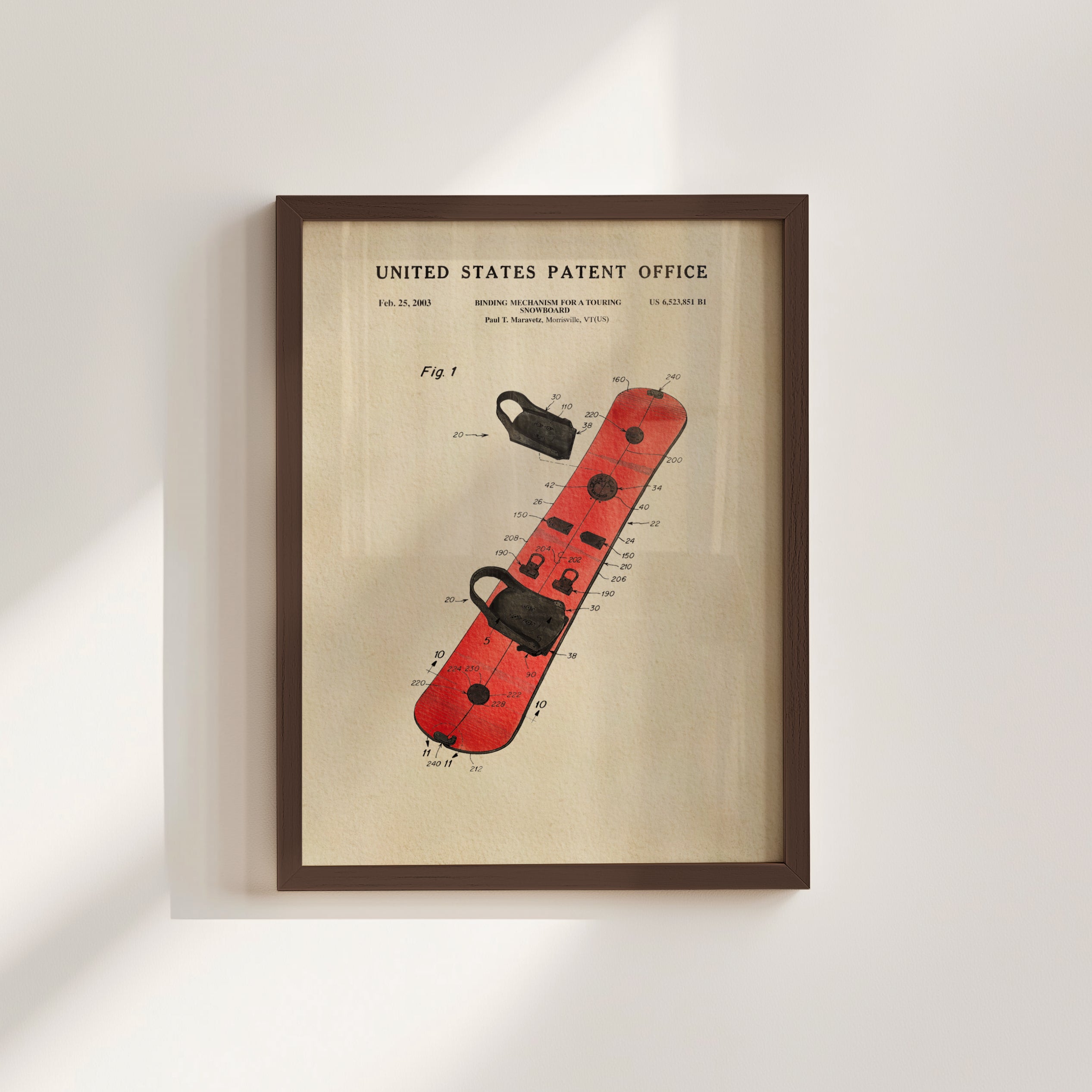 The image is a framed patent drawing of a red snowboard with various technical drawings and text.