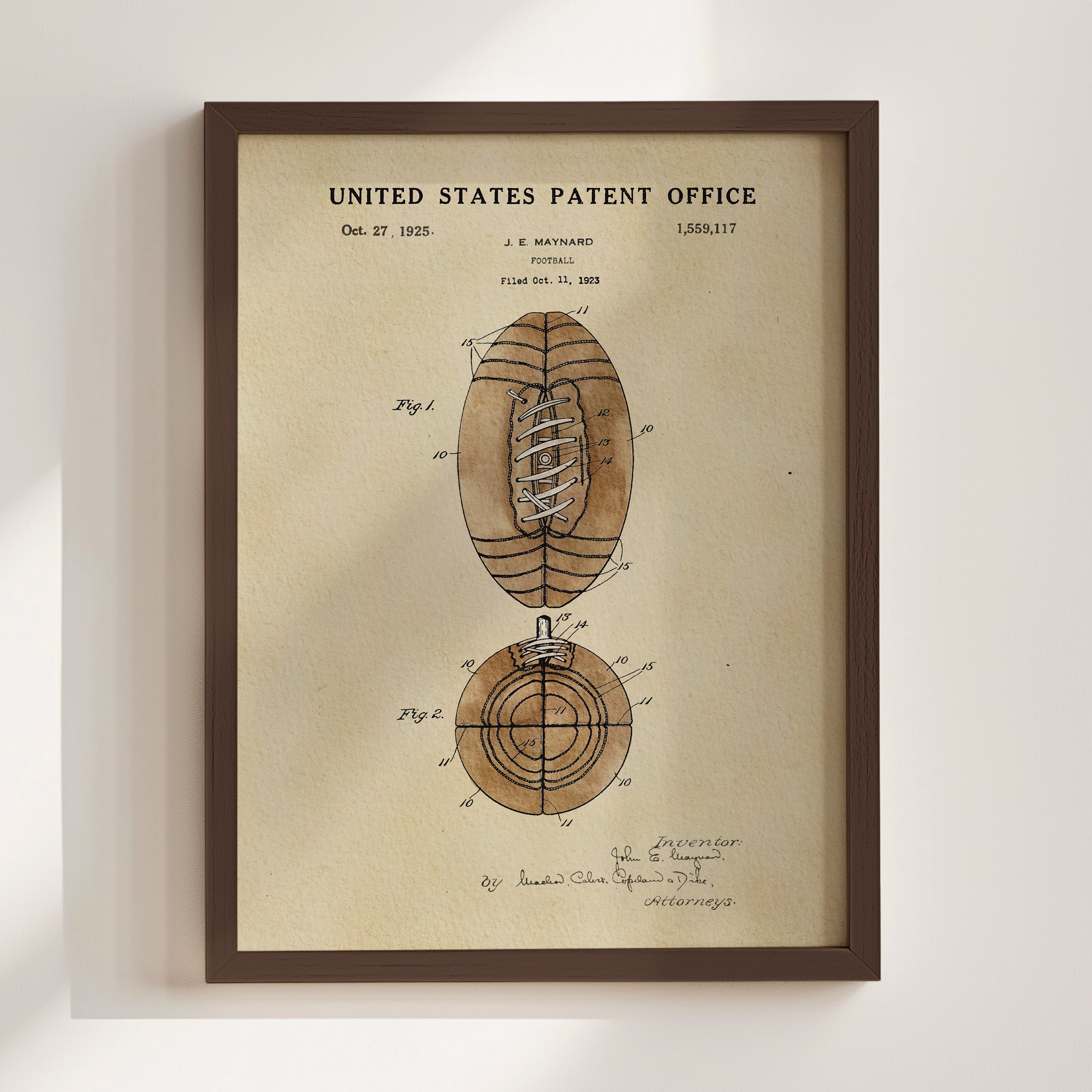 The image is a framed print of a United States patent from October 27, 1925, depicting a football.