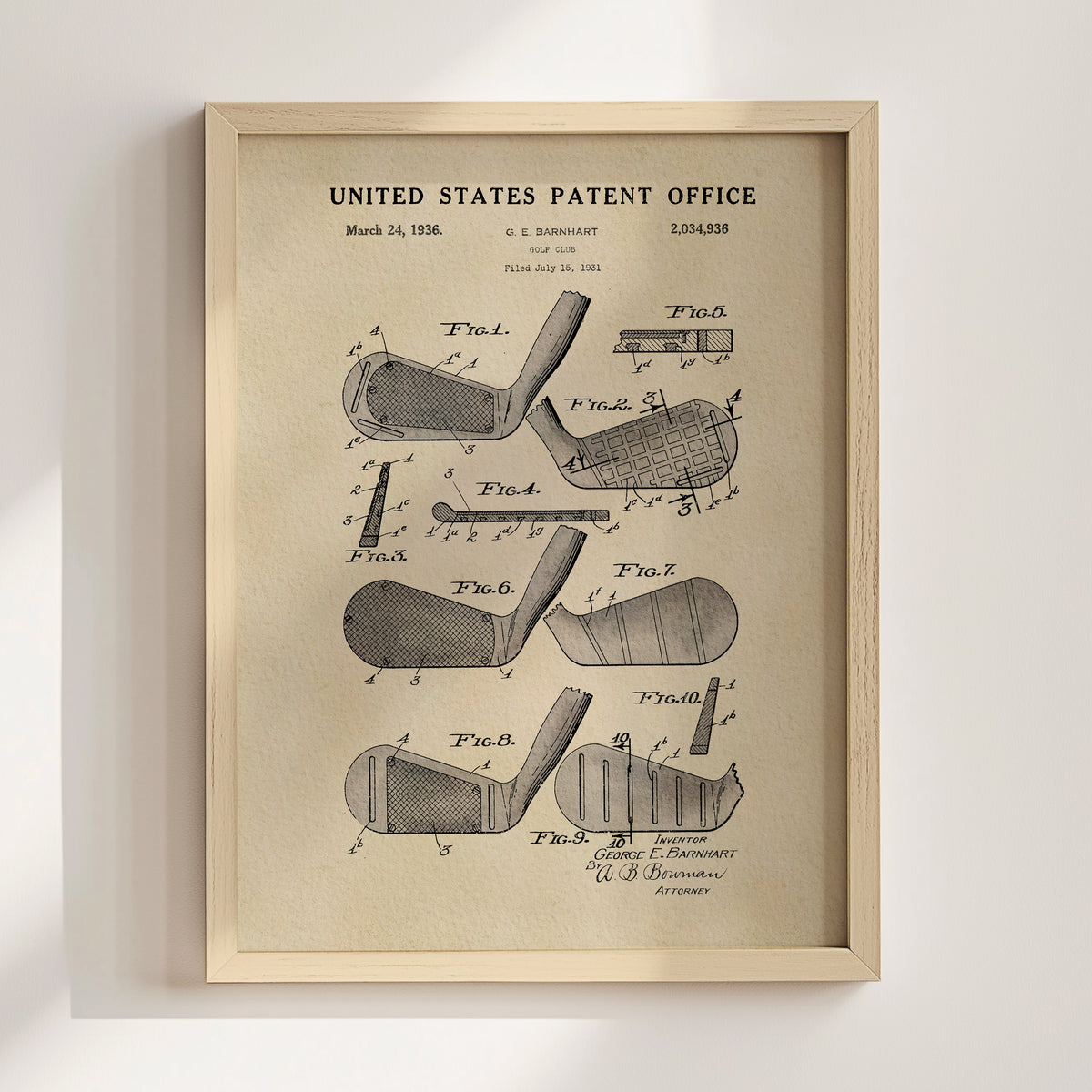 The image is a framed vintage patent drawing of a golf club, depicting various parts of the club such as the head, shaft, and grip.