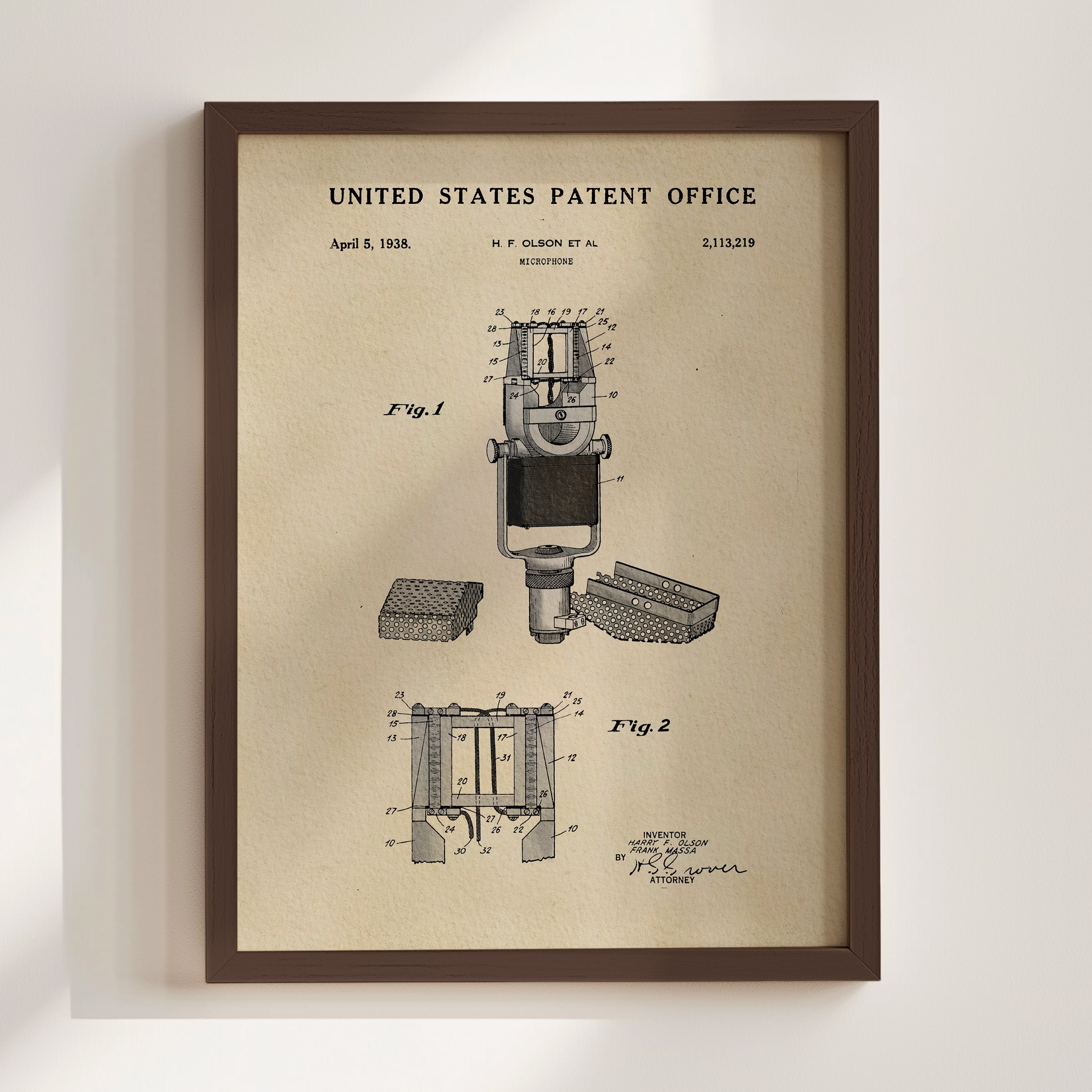 The image is a framed vintage patent drawing of a microphone, depicting its design and features.