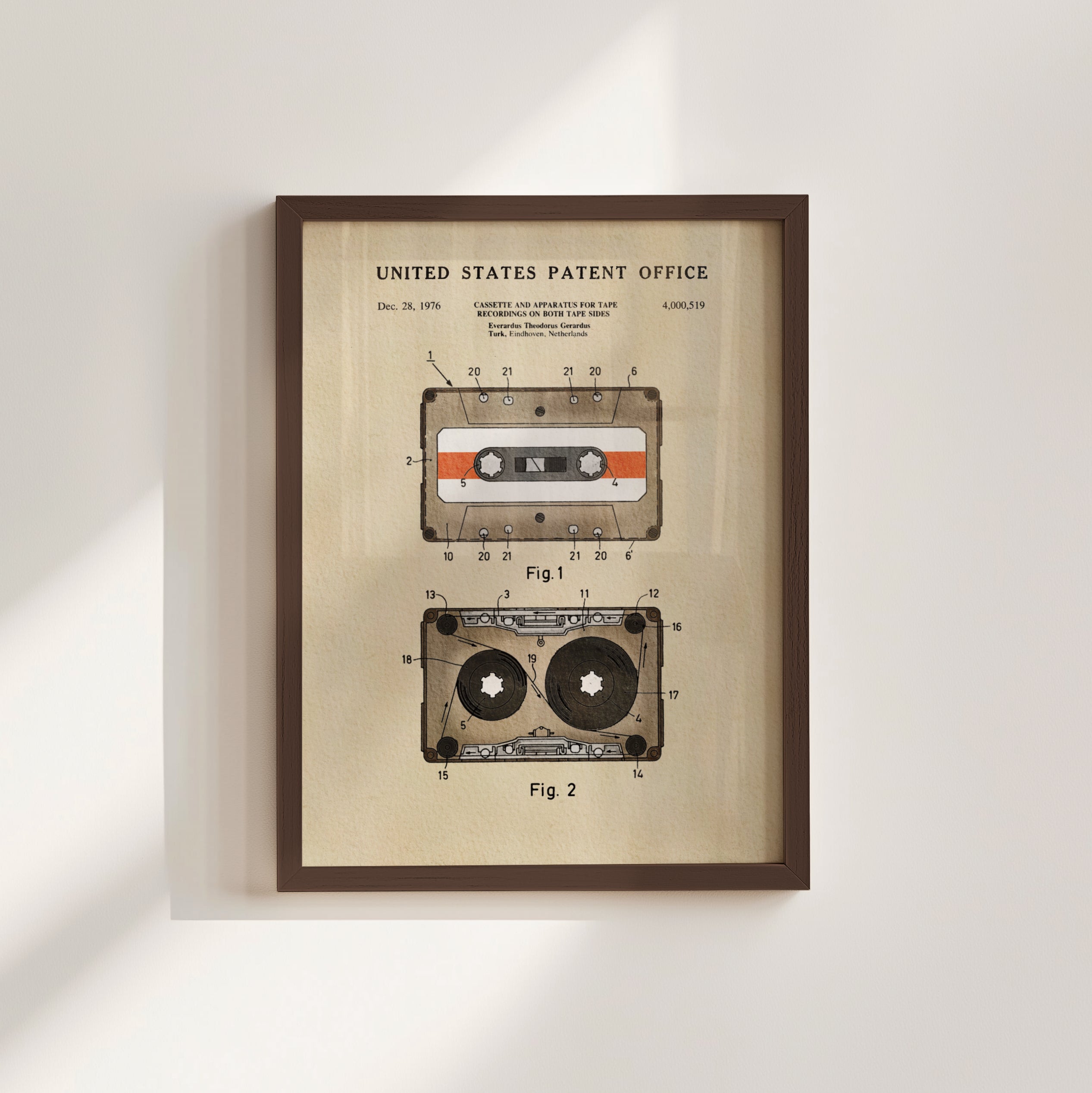The image is a framed patent drawing depicting a cassette tape and a tape recorder, both with a vintage design.