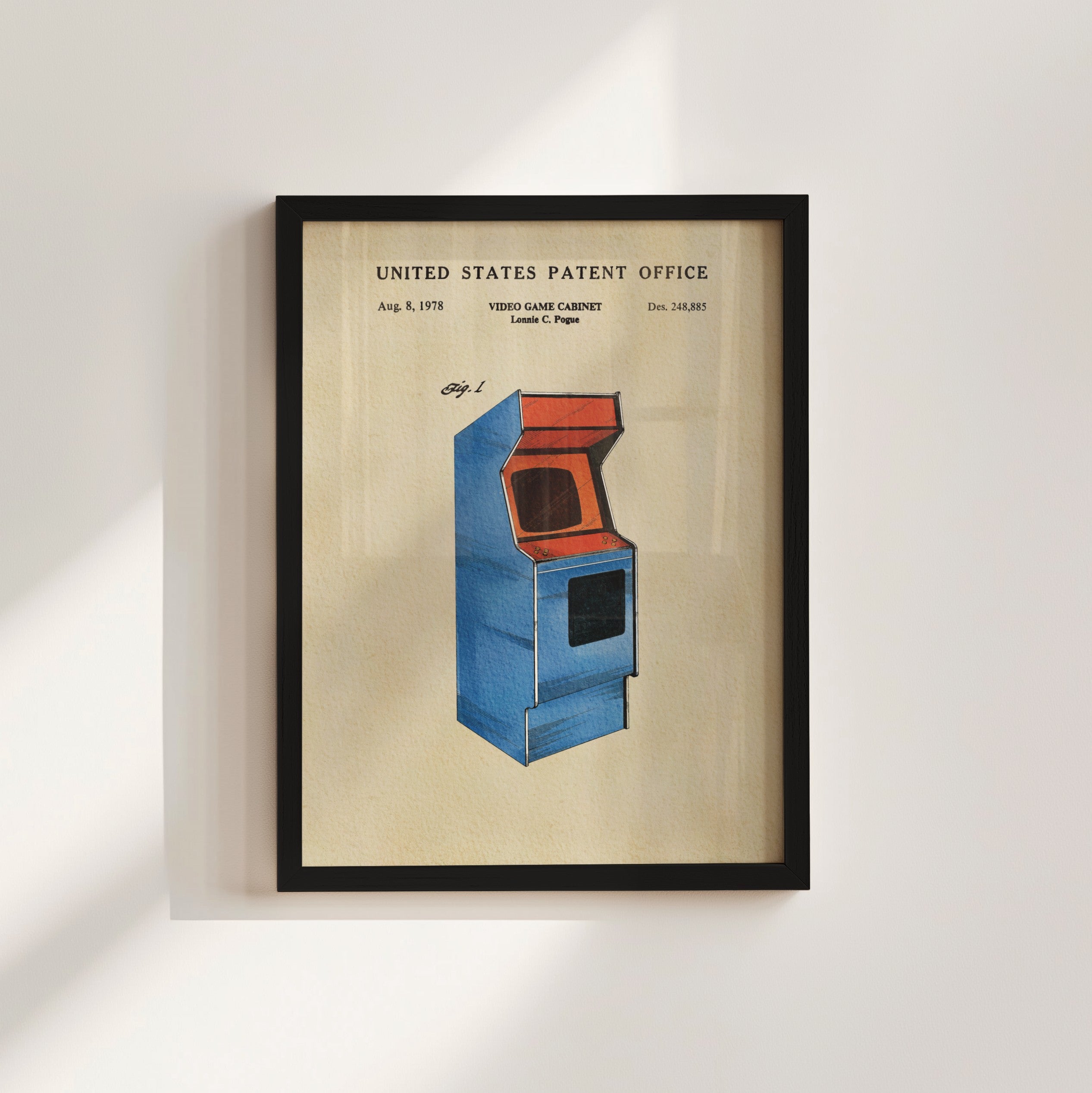 The image is a framed patent drawing of a blue arcade cabinet, depicting a vintage video game cabinet design from the United States Patent Office.