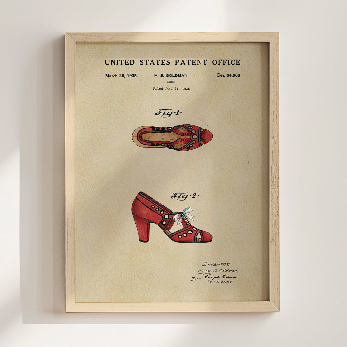 The image is a framed patent application from the United States Patent Office dated March 26, 1935, featuring a patent for a red high-heeled shoe.