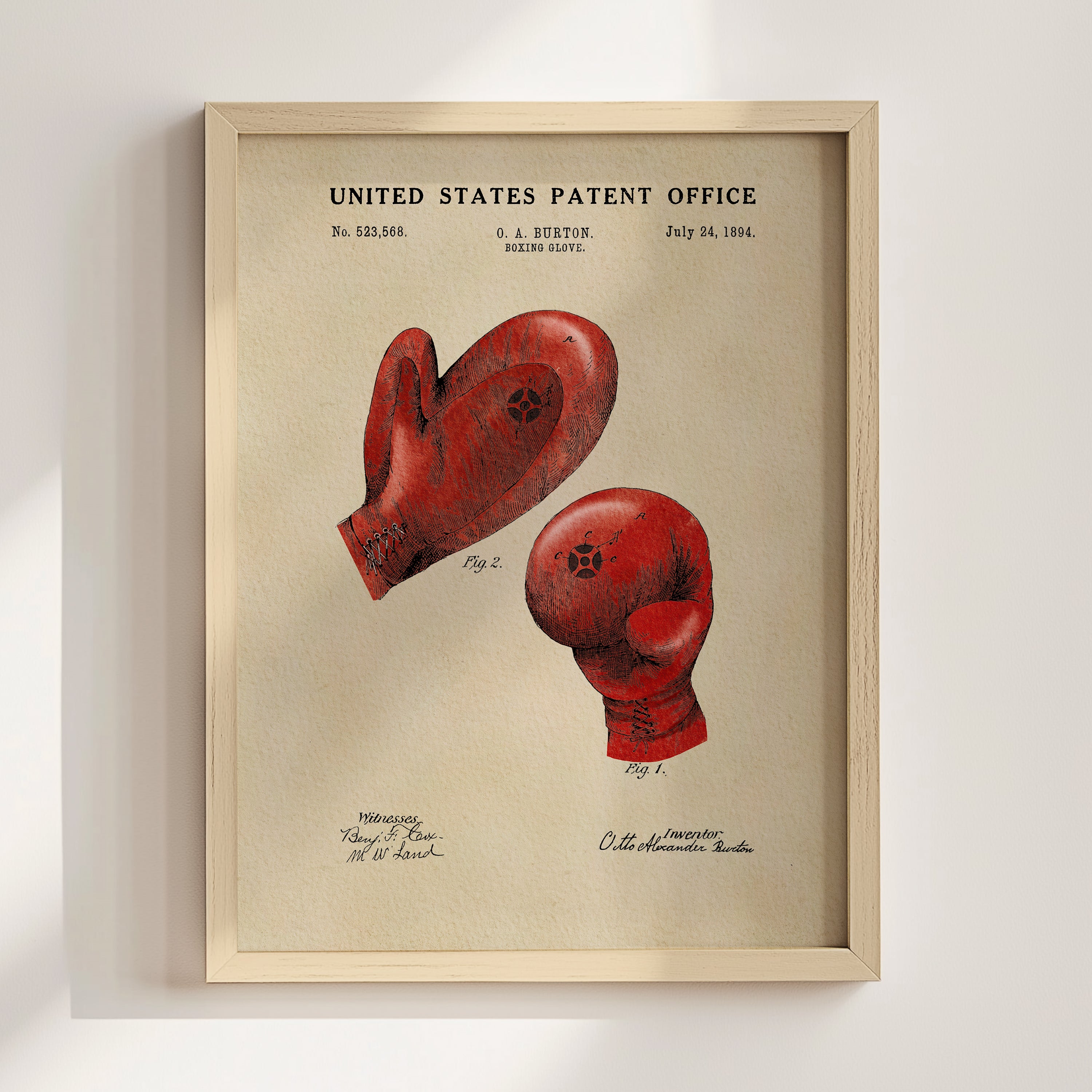 The image is a framed print of a red boxing glove with a patent application from the United States Patent Office dated July 24, 1884.