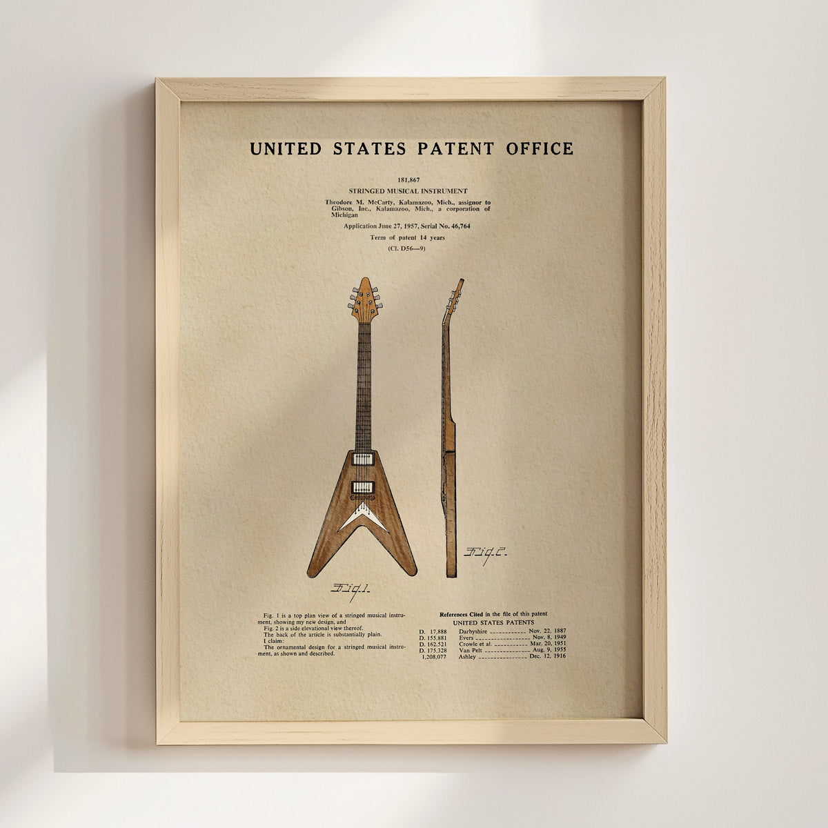 The image is a framed print of a patent application for a guitar, featuring a detailed illustration of the guitar design.