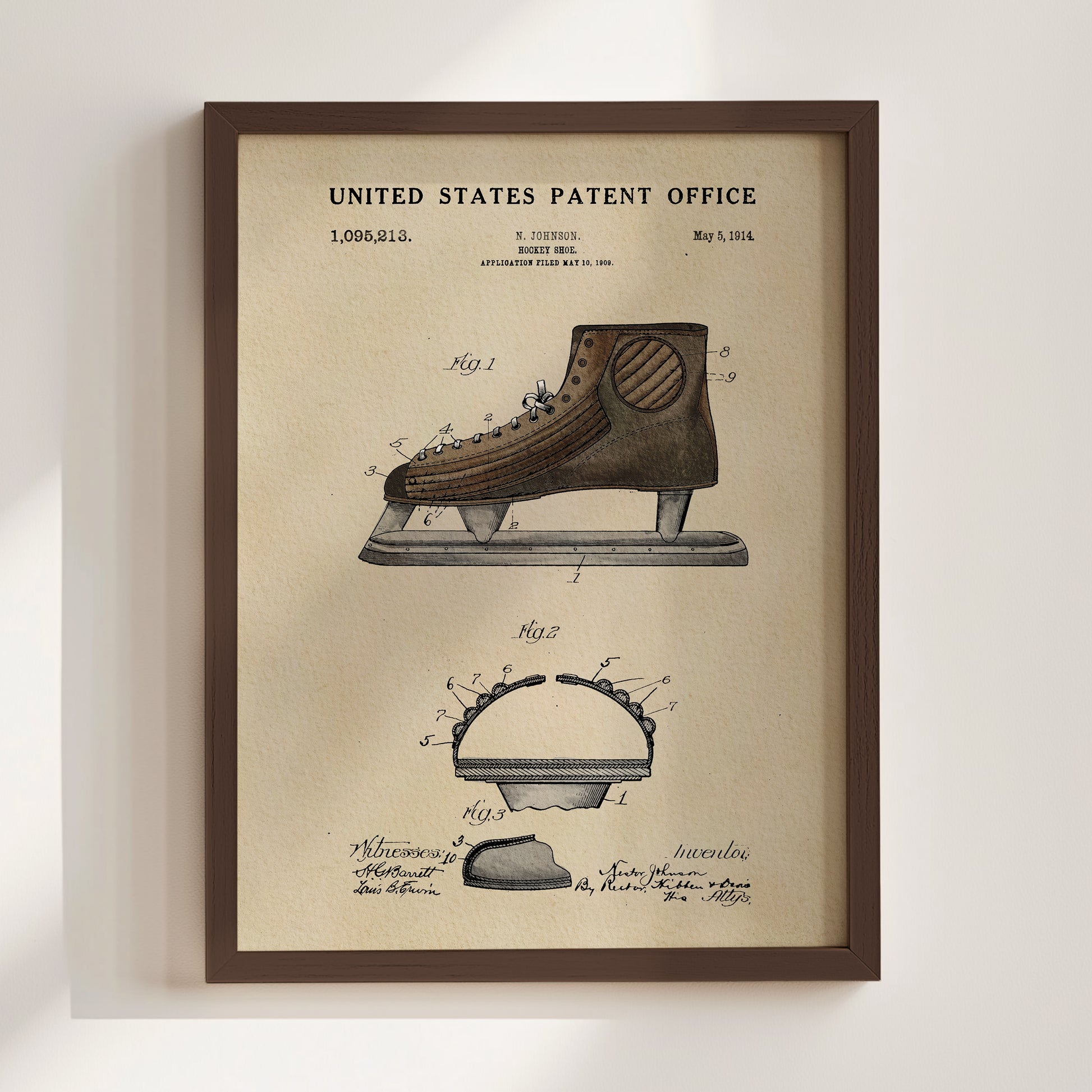 The image is a framed vintage patent drawing of a pair of skates, depicting the design and features of the invention.