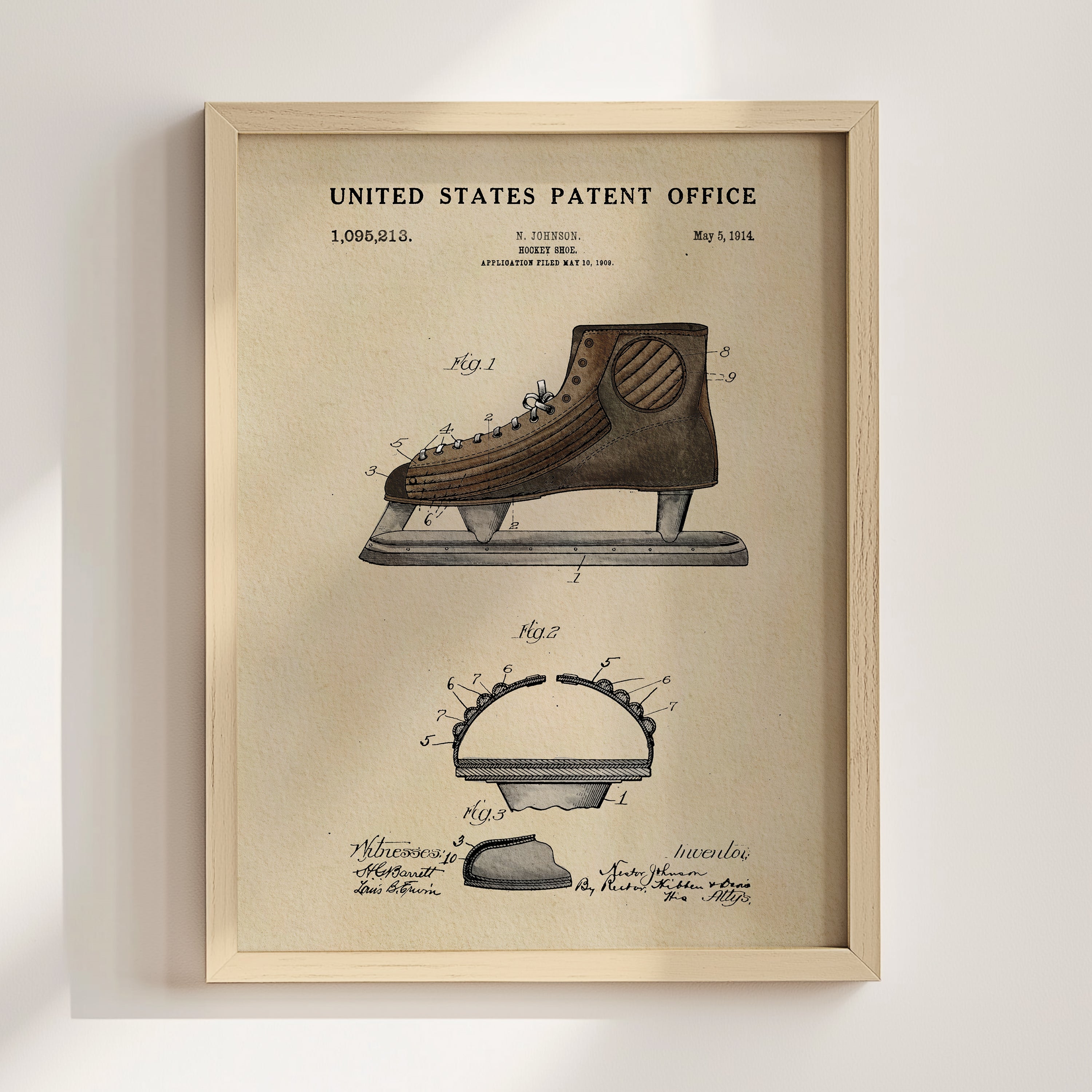 The image is a framed vintage patent drawing of a pair of skates, depicting the design and features of the invention.