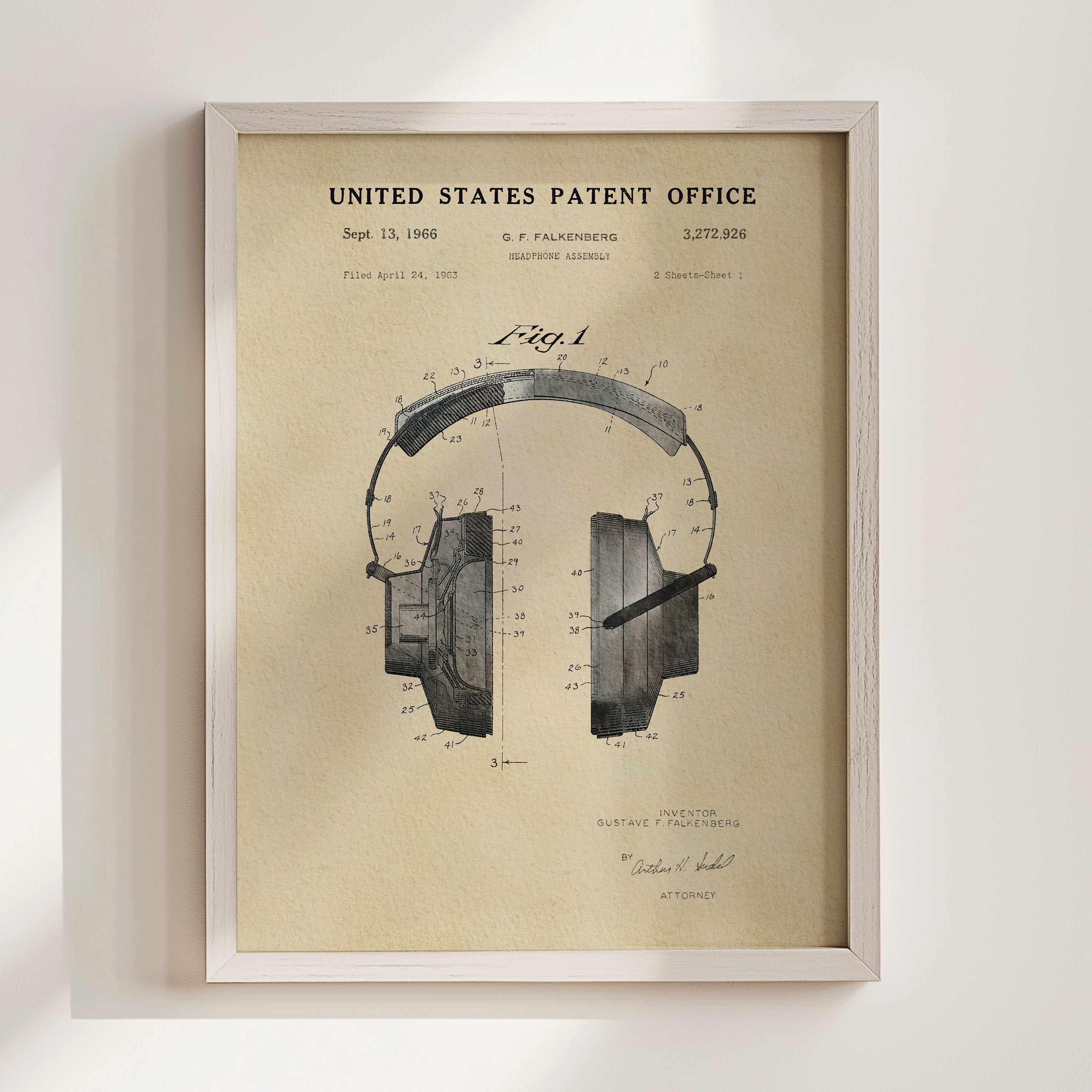 The image is a framed vintage patent drawing of a pair of headphones, depicting the design and features of the headphones.
