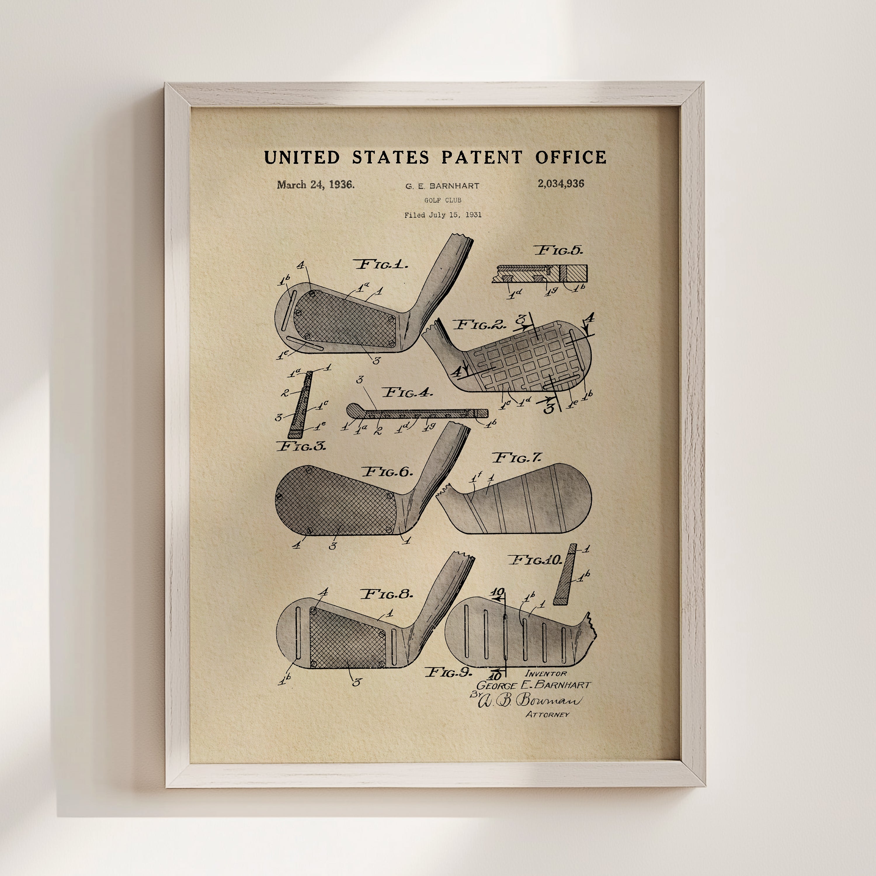 The image is a framed vintage patent drawing of a golf club, depicting various parts of the club such as the head, shaft, and grip.