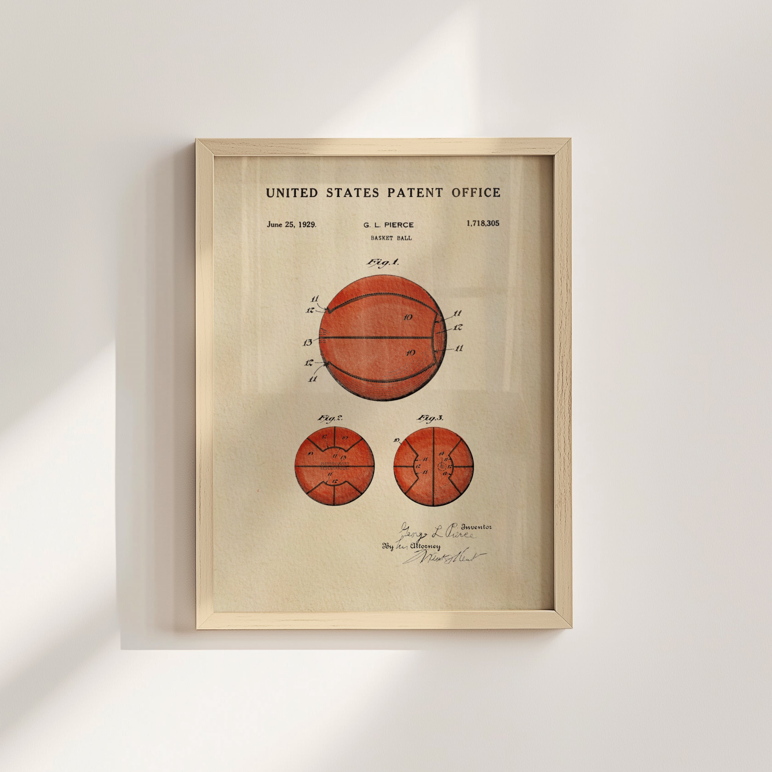 The image is a framed vintage patent drawing of a basketball, depicting the design of the basketball with a signature and date.